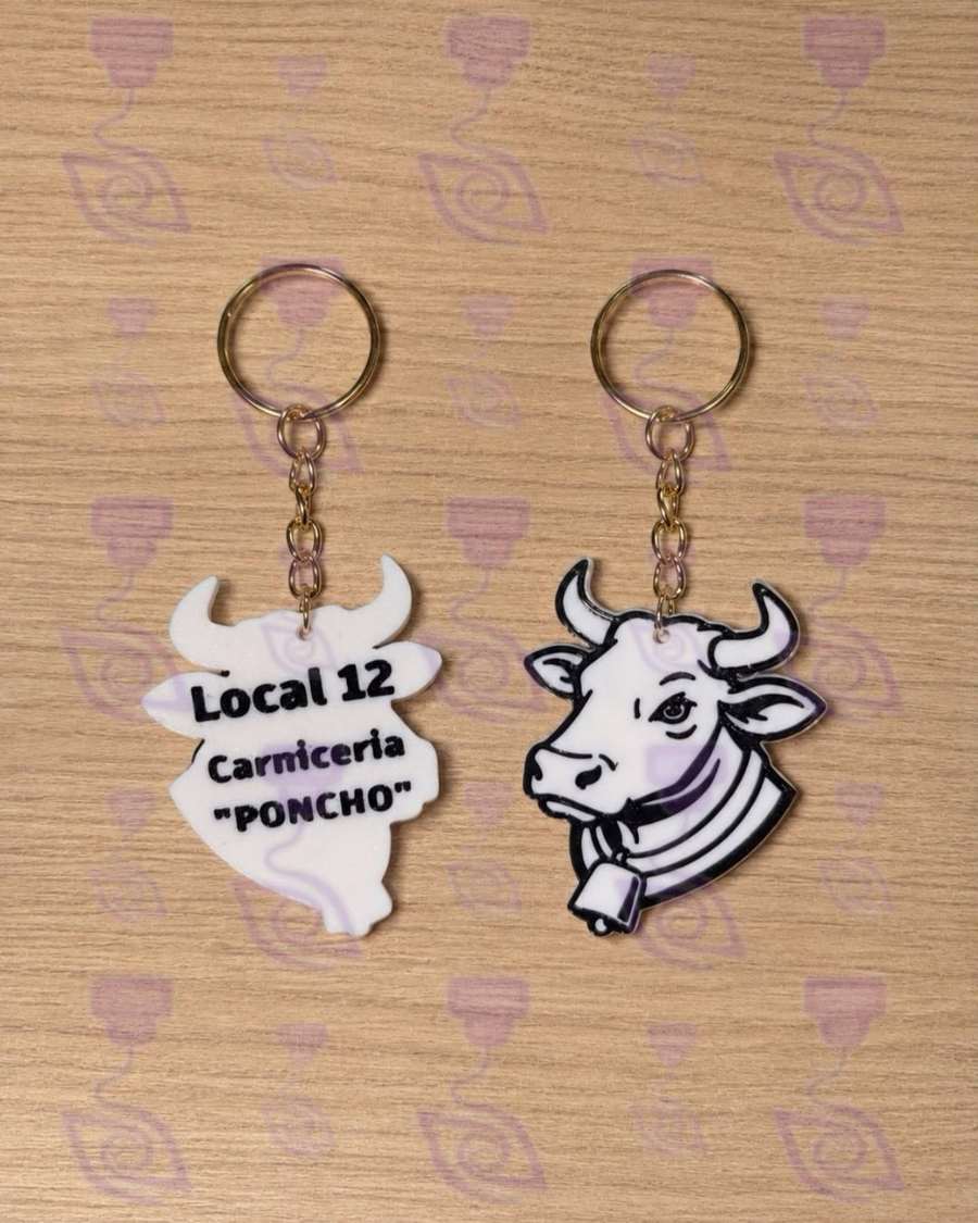 Dos llaveros en forma de vaca con el texto Local 12 Carnicería Poncho